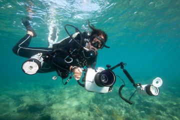 Photographer Cristina Mittermeier underwater with her photography gear