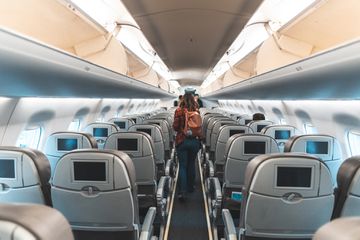 Woman walking the aisle on plane