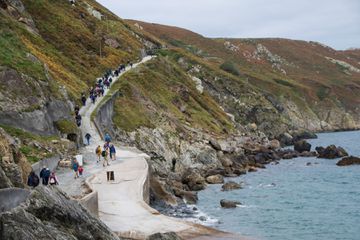  Visitors on Lundy Island make their way up the steep road from the harbour onto the main Island in the UK