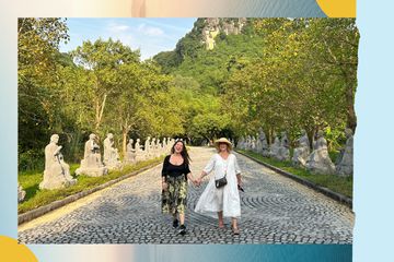 Mother and daughter holding hands walking in Asia
