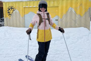 A person in ski gear wearing the Outdoor Research Women's Carbide Jacket