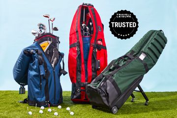 Three travel golf bags displayed on grass