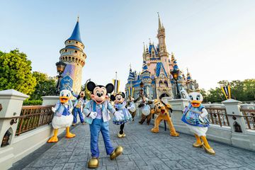 Disney characters outside of Cinderella's Castle at Disney World